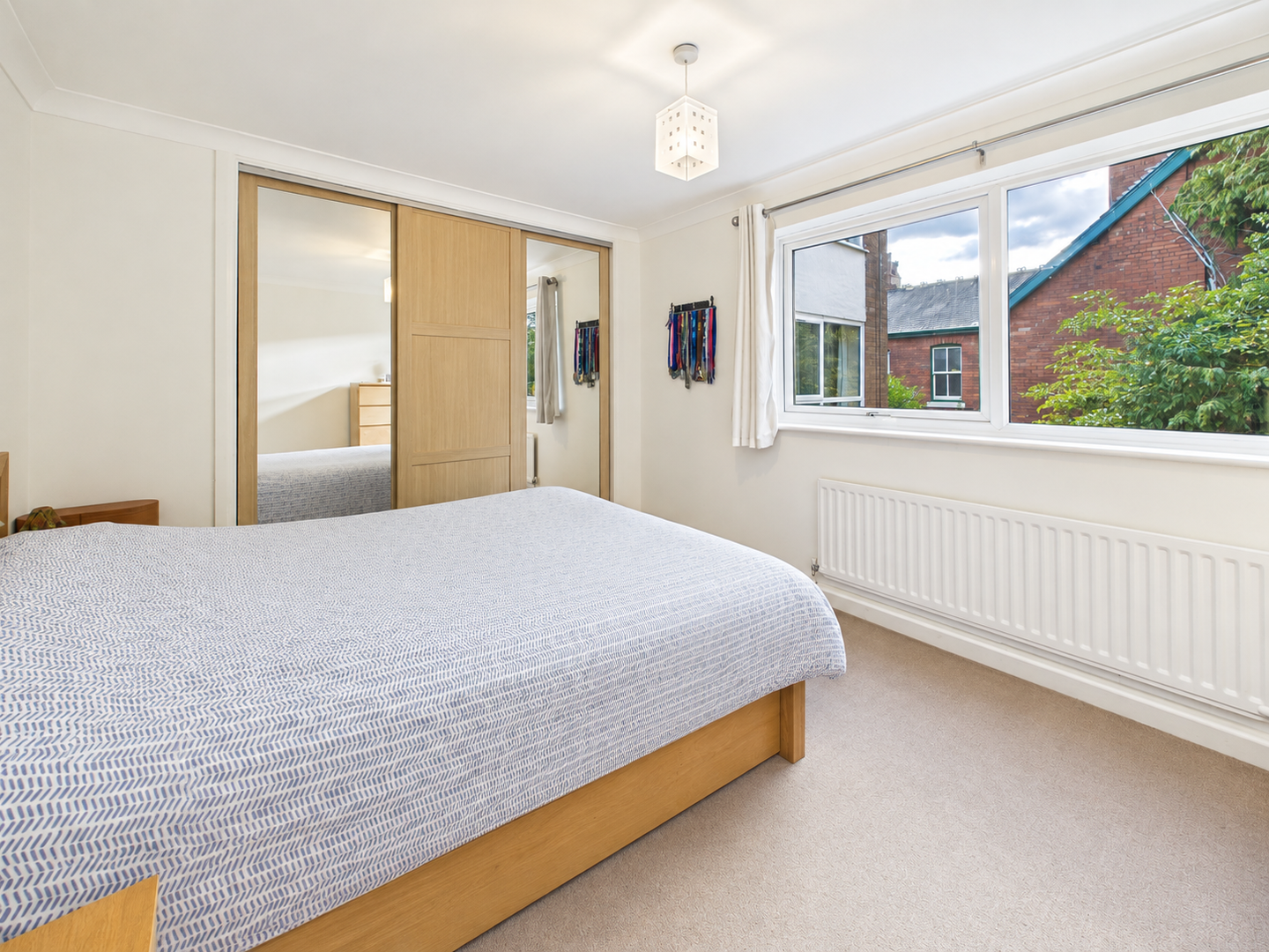 neatlymadebedroomwithmedaldisplay